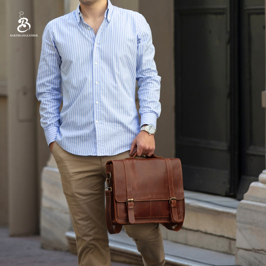 Man carrying a chestnut full grain leather briefcase by its top handle