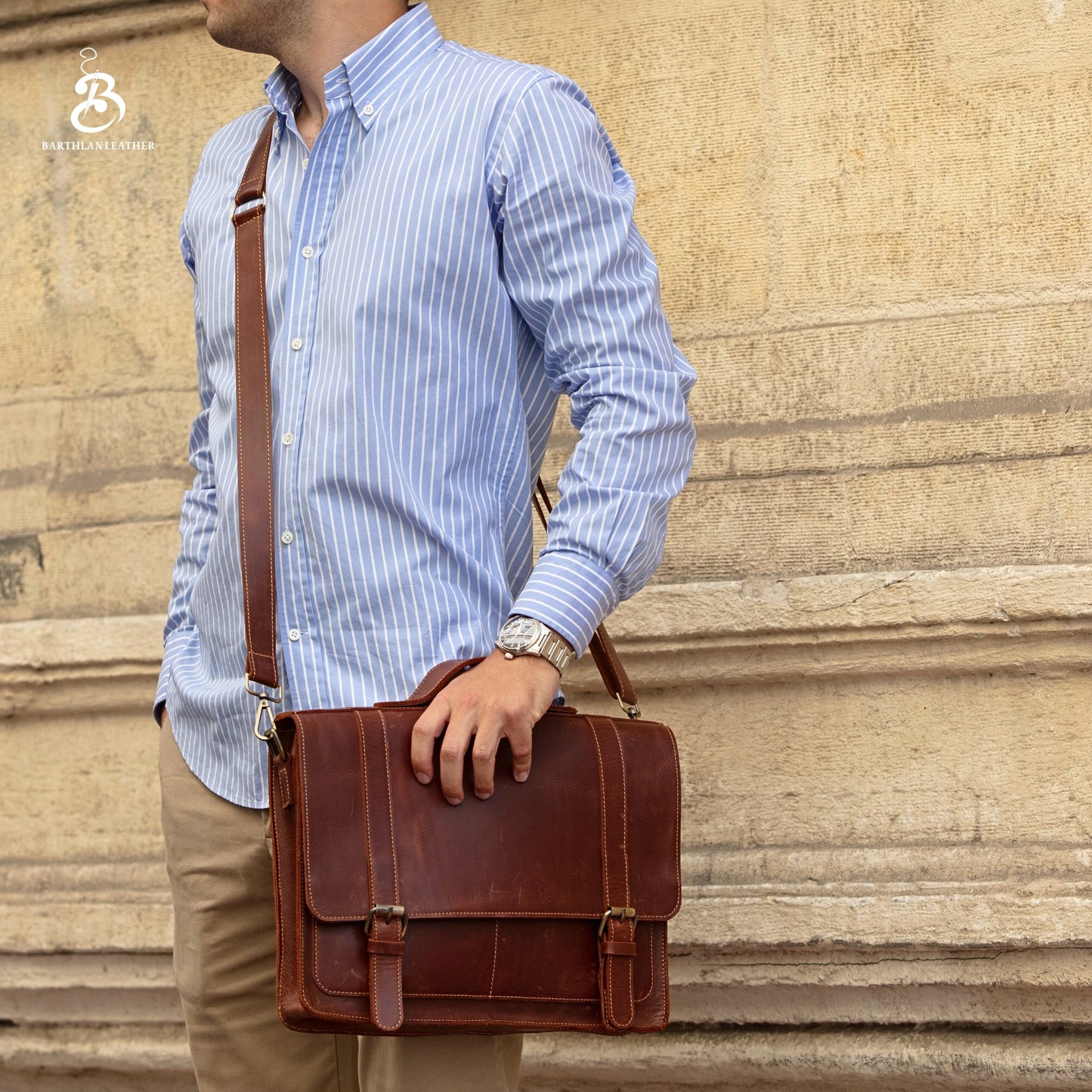 Man wearing a chestnut leather briefcase as a shoulder bag