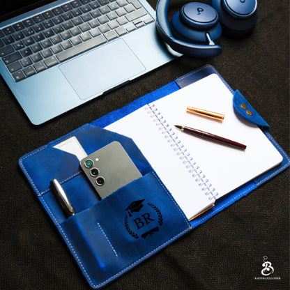 Personalized blue A5 portfolio open with notebook, phone, and pen