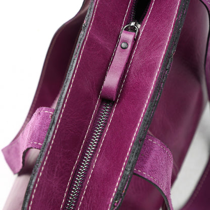 Close-up of purple leather tote zipper and shoulder straps