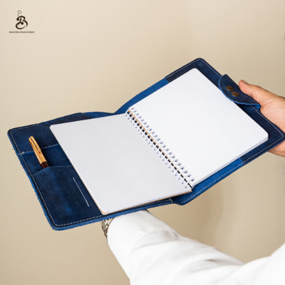 Open blue A5 leather portfolio held in one hand