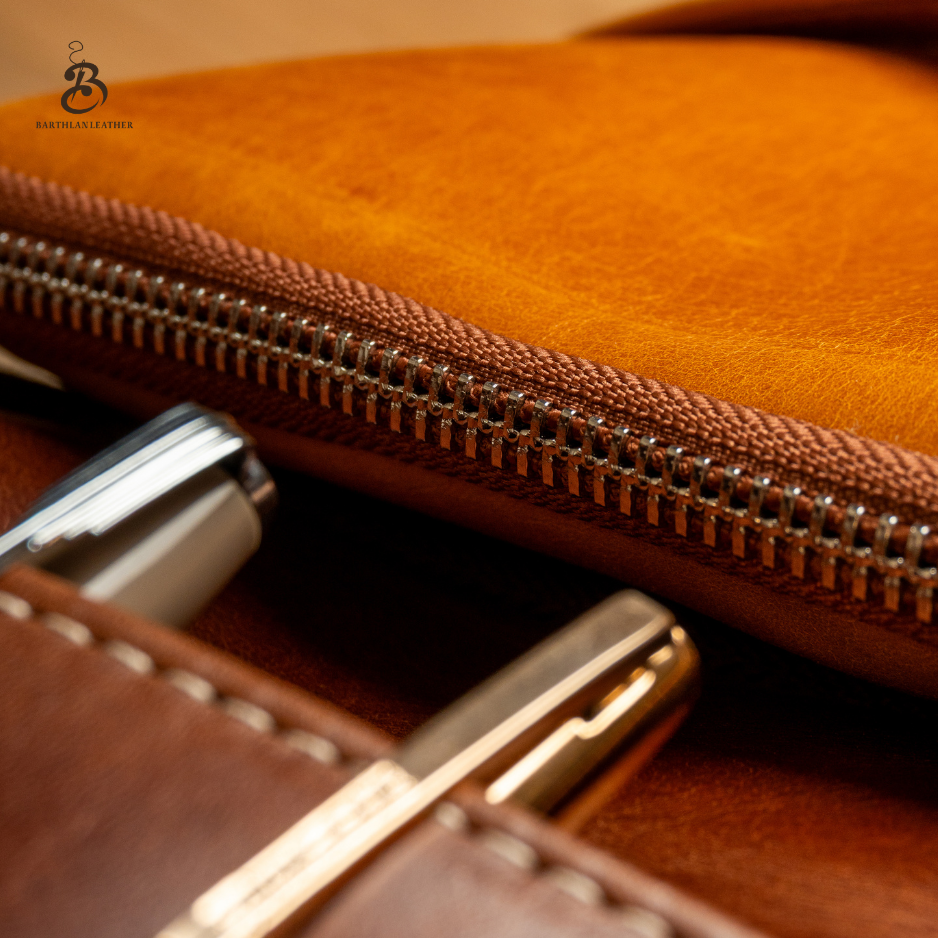 Close-up of brass zipper and full grain leather texture