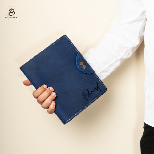 Person holding a closed blue A5 leather portfolio