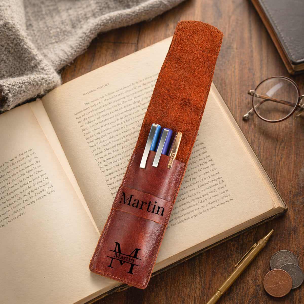 Open personalized leather pen sleeve holding three pens