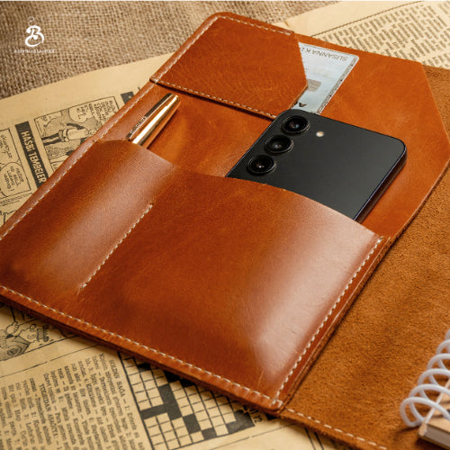Open chestnut A5 portfolio with a smartphone in the interior pocket