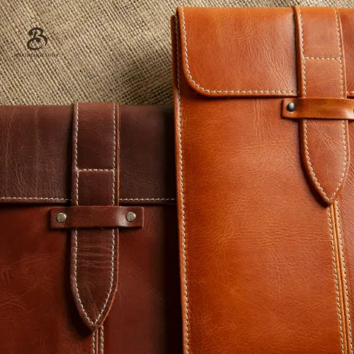 Front view of camel and brown leather tablet sleeves with flap closure