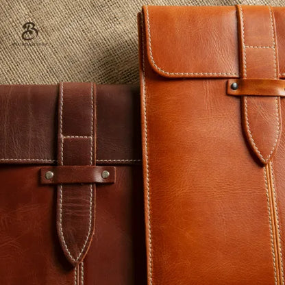 Front view of camel and brown leather tablet sleeves with flap closure