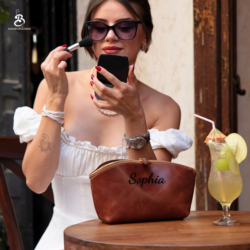 Woman applying lipstick beside a brown leather cosmetic pouch