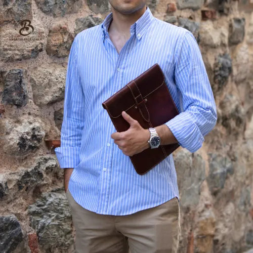 Man carrying a brown full grain leather iPad sleeve