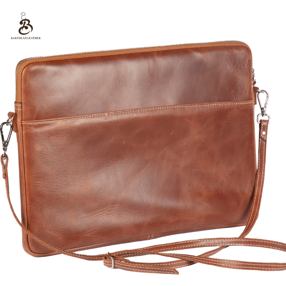 Front view of a chestnut leather laptop bag with shoulder strap