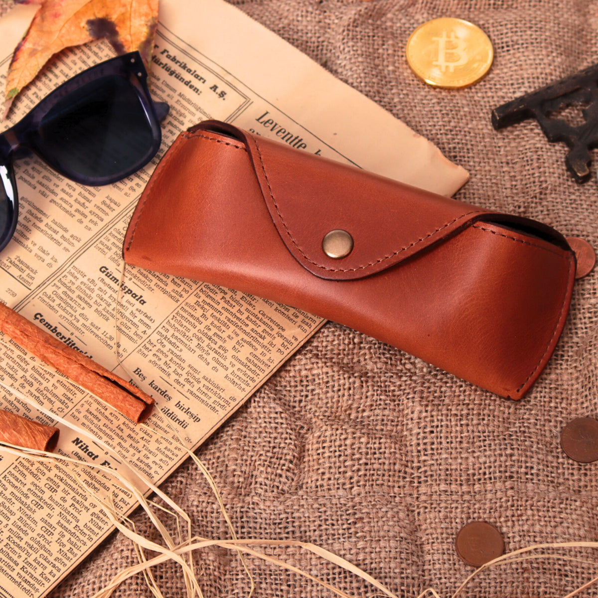 Closed chestnut leather eyeglasses case with snap flap