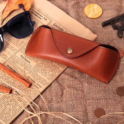 Closed chestnut leather eyeglasses case with snap flap