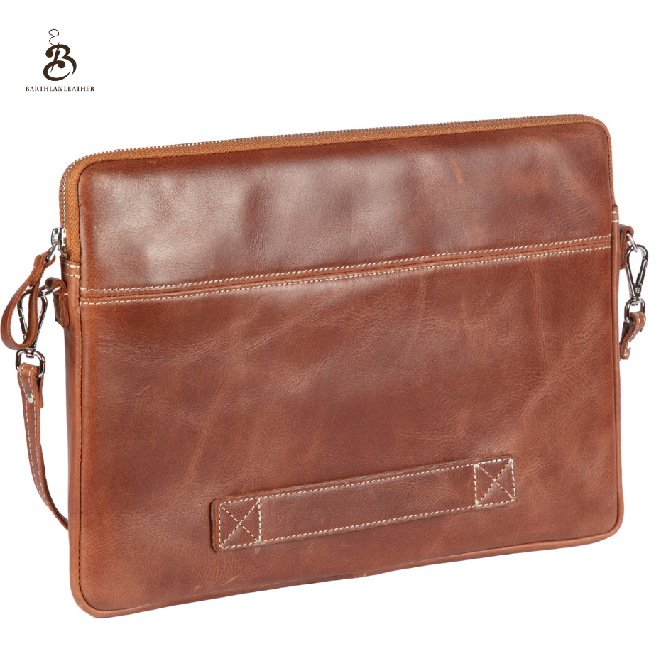 Back view of a chestnut leather laptop bag with carry handle